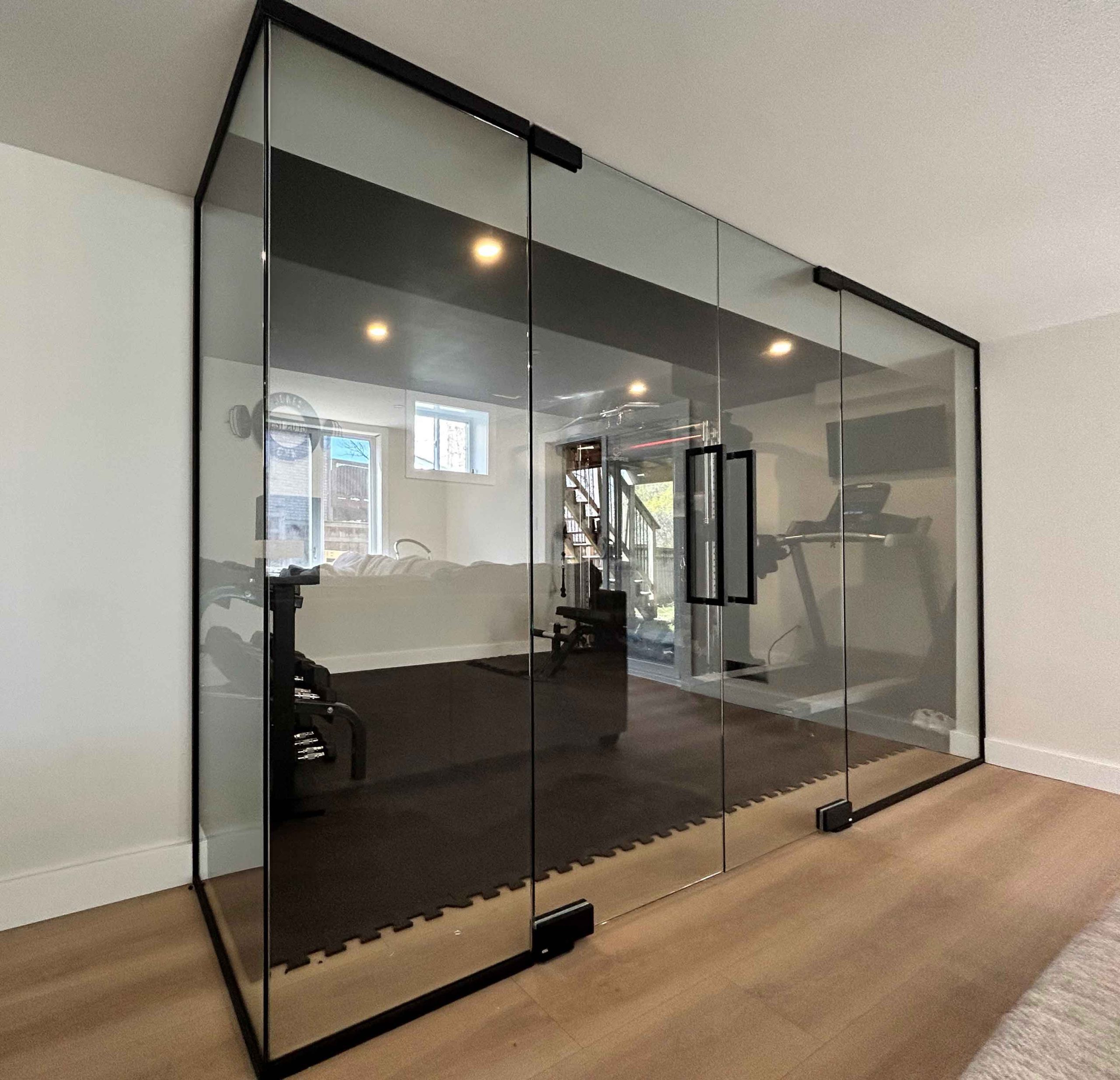 Glass wall and partitions with sliding door for home gym